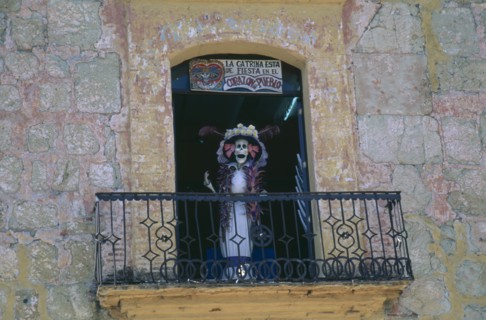 MEXICO, Oaxaca, Skeleton figure on shop window balcony for Day of the Dead.