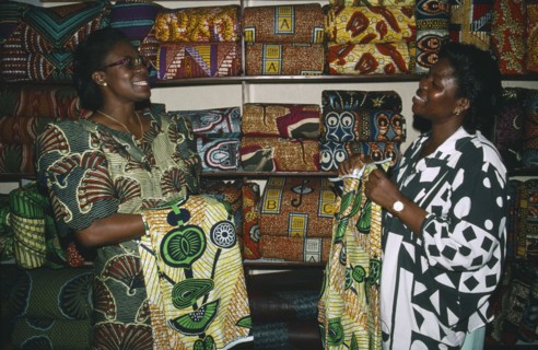 TOGO, Lome, Female cloth vendors selling traditional cloth at market.