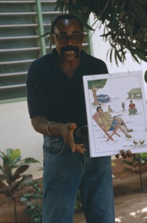 TOGO, Lome, Male teacher using story boards to demonstrate AIDS awareness and safe sex message.