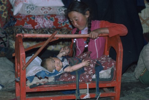 CHINA, Xinjiang Province, Altai Mountains, Kazakh siblings inside kigizuy.