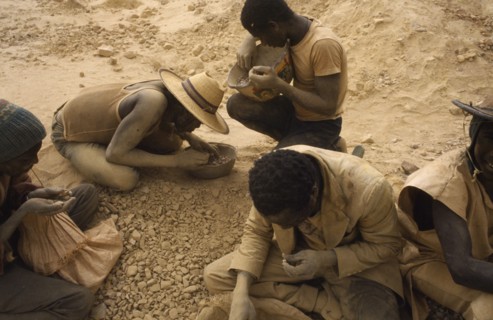 BURKINA FASO, Sahel, Dust covered group of gold miners.