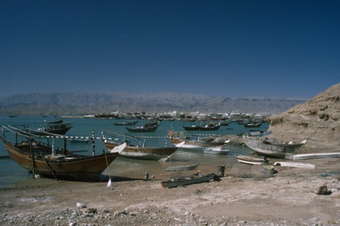 OMAN, Sur, Boats moored along coastline.