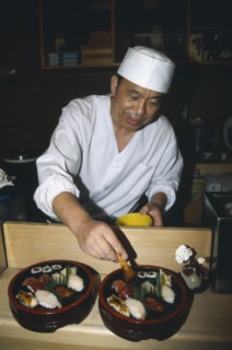 JAPAN, Honshu, Tokyo, Sushi chef preparing dish.