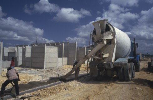 WEST INDIES, Dominican Republic, Construction, Laying concrete pavement on building site.