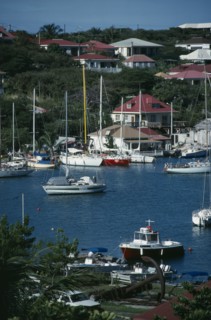 WEST INDIES, St Barthelemy, Gustavia, View over the port with white boats moored on water.