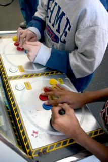 USA, Minnesota, St Paul, Hands of players age 10 intently playing a video game during a Youth