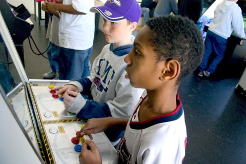 USA, Minnesota, St Paul, Friends age 10 playing video games developing their eye hand coordination