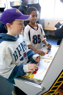 USA, Minnesota, St Paul, Friends age 10 playing video games developing their eye hand coordination