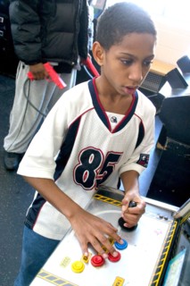 USA, Minnesota, St Paul, Young black child aged 10 playing video games developing his eye hand