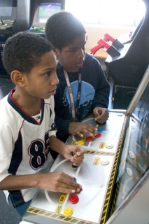 USA, Minnesota, St Paul, Friends age 11 playing video games developing their eye hand coordination
