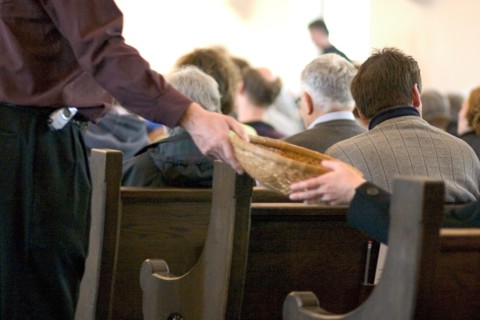 USA, Minnesota, St Paul, Passing offering basket at church.