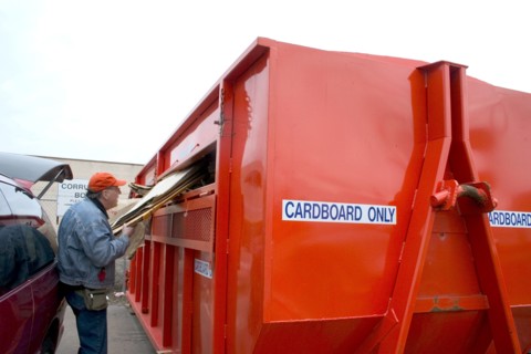 USA, Minnesota, St Paul, Recycling cardboard in a large orange dumpster at Vasko Disposal Solutions