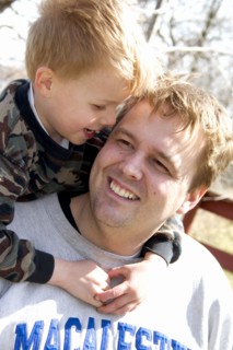 USA, Minnesota, Clitherall, Son talking to dad with arms around his neck.