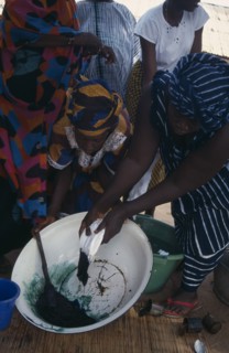 GAMBIA, Work, Women tie dye fabric.