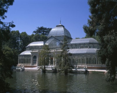 SPAIN, Madrid State, Madrid , Retiro Park. The Crystal Palace surrounded by trees seen from across