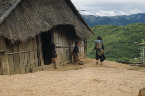 LAOS, Traditional Housing, Meo children outside thatched house in village near Luang Prabang.
