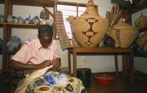 TANZANIA, West, Great Lakes Region, Refugee making traditional woven baskets.