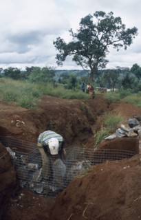 TANZANIA, West, Great Lakes Region, Refugees making gambions from stone filled wire cages to