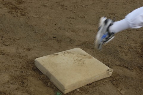 JAPAN, Chiba, Tako, Little league players foot rounds first base during practice at Toujou Shonen