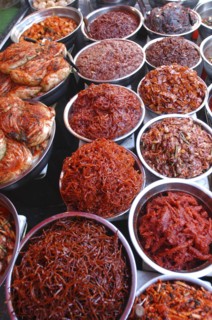 KOREA, Seoul, Namdaemun Market. Varieties of kimchi displayed on a stall