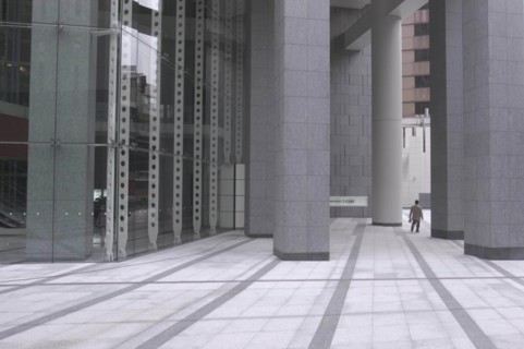 JAPAN, Honshu, Tokyo, "Roppongi ""Salariman"" officeworker crosses building plaza"