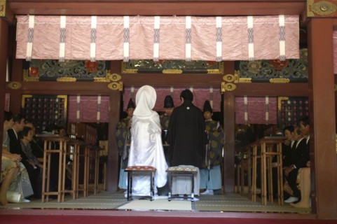 JAPAN, Honshu, Tokyo, "Nezu Jinja. Shinto priests give sake to bride and groom, both in traditional