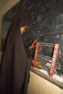 SOMALILAND, Hargeisa, Ali Osman Primary School.  Girl using abacus in classroom.