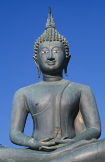 SRI LANKA, Colombo, Seema Malakaya on Beira Lake. Seated Buddha statue against a blue sky