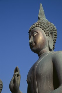 SRI LANKA, Colombo, Seema Malakaya on Beira Lake. Angled view looking up at the head and hand of a