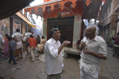 INDIA, Uttar Pradesh, Varanasi , Bengali Tole. Two middle aged men have a morning coversation