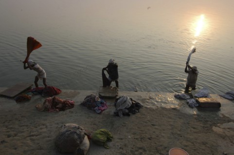 INDIA, Uttar Pradesh, Varanasi , Near Shivala Ghat. Dhobi clothes washers working on the banks of