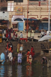 INDIA, Uttar Pradesh, Sarnath, Dashaswamedh Ghat with early morning bathers in the Ganges River