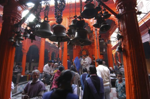 INDIA, Uttar Pradesh, Varanasi , Kala Bhairava Temple. Temple interior with bells and worshippers