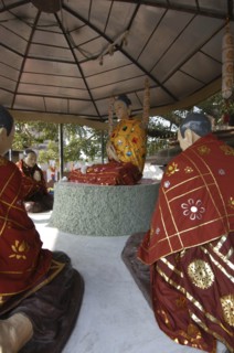 INDIA, Uttar Pradesh, Sarnath, Statues of the Buddha preaching his first sermon in front of the