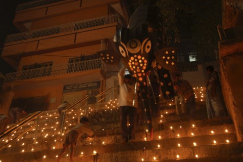 INDIA, Uttar Pradesh, Varanasi, Deep Diwali Festival with men carrying paper statue of Hindu God