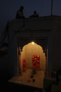 INDIA, Uttar Pradesh, Varanasi, Near Hanuman Ghat. A Hanuman Shrine on the Ganges River at night