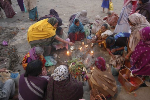 INDIA, Uttar Pradesh, Varanasi, Hindu women worshipping an earthen image of Hindu God Bhim at Asi
