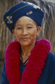THAILAND, Chiang Rai, Mae Chan District. Portrait of a Iu Mien woman in traditional attire at her