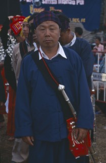 THAILAND, Chiang Mai Province, Samathi Mai, Kachin Manou. Kachin elder in line awaiting the start