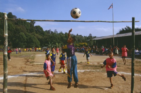 THAILAND, Chiang Rai Province, Doi Lan, Lisu boys playing soccer in a village school yard