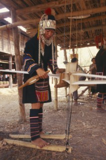 THAILAND, Chiang Mai Province, Akha woman weaving cloth on an Akha loom