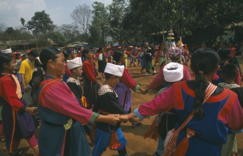 THAILAND, Chiang Rai Province, Huai Khrai, Lisu people dancing around a New Year tree to a banjo