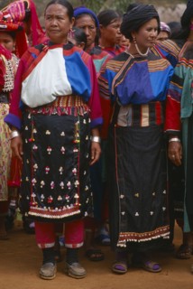 THAILAND, Chiang Rai Province, Huai Khrai, Lisu women wearing seldom worn aprons with silver ear