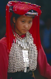 THAILAND, Chiang Rai Province, Huai Khrai, Portrait of a young Lisu woman wearing her New Year