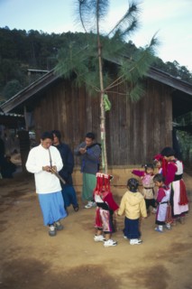 THAILAND, Chiang Rai Province, Doi Lan, Lisu men play gourd pipes as children dance around the New