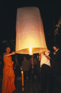 THAILAND, Chiang Mai, Wat Chaimongkon, Loi Krathong Festival aka Yi Peng. Monk and other people