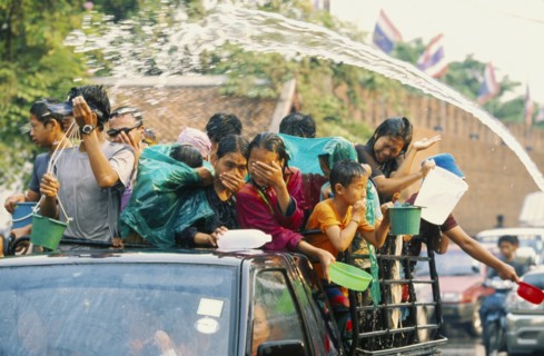 THAILAND, Chiang Mai, Songkran aka Thai New Year. Revellers in a pickup truck attempting to catch