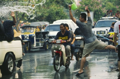 THAILAND, Chiang Mai, Songkran aka Thai New Year. Revellers in a pickup truck attempting to catch