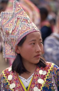 THAILAND, Chiang Mai, Hmong New Year. Portrait of a young Hmong woman in her New Year finery