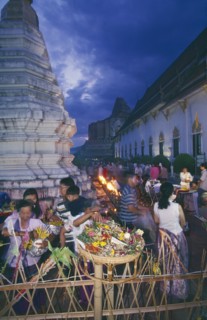 THAILAND, Chiang Mai, Wat Jedi Luang, Inthakhin Ceremony. People with offerings of flowers and joss